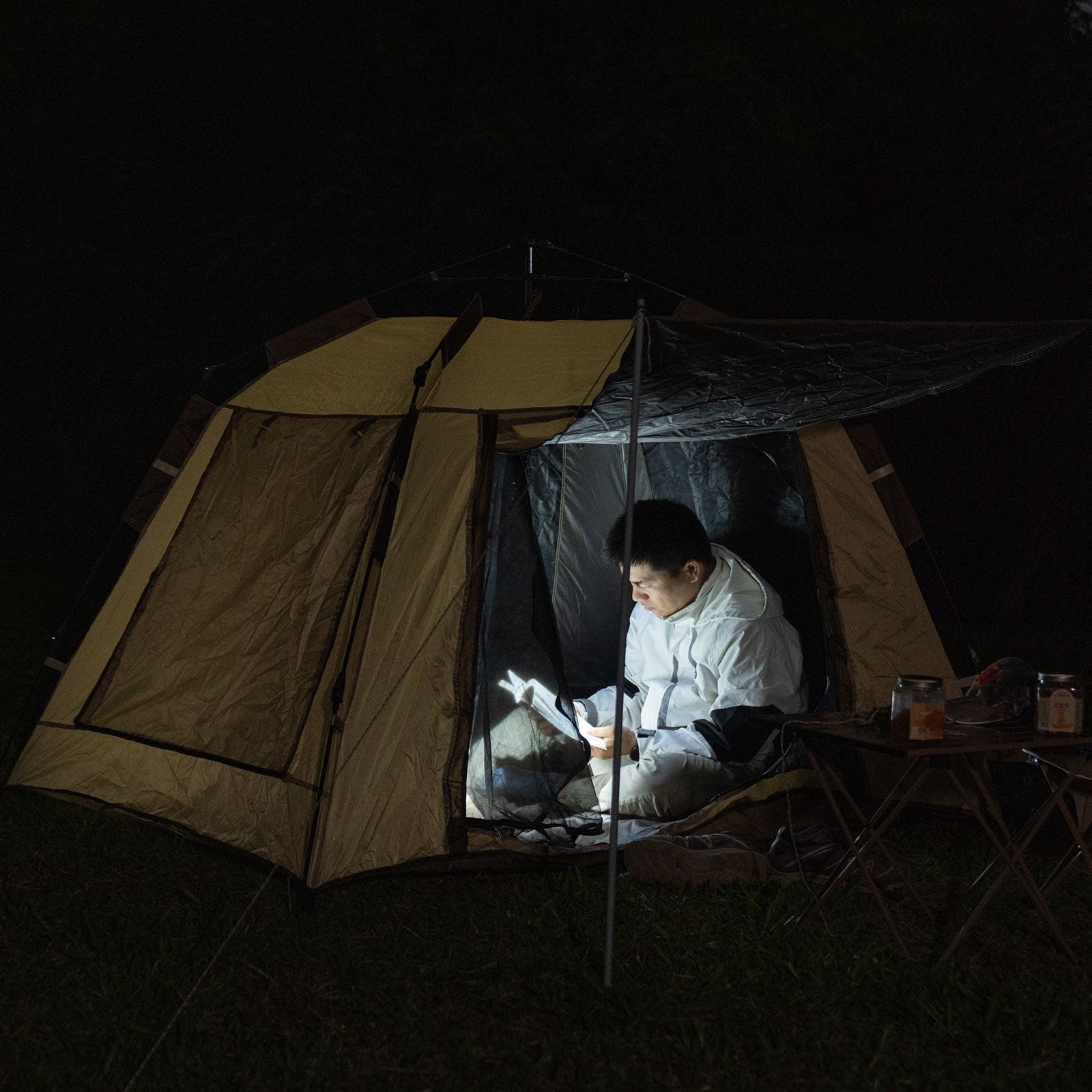 Image of Person inside a tent at night using RovyVon SL10, with a dark background